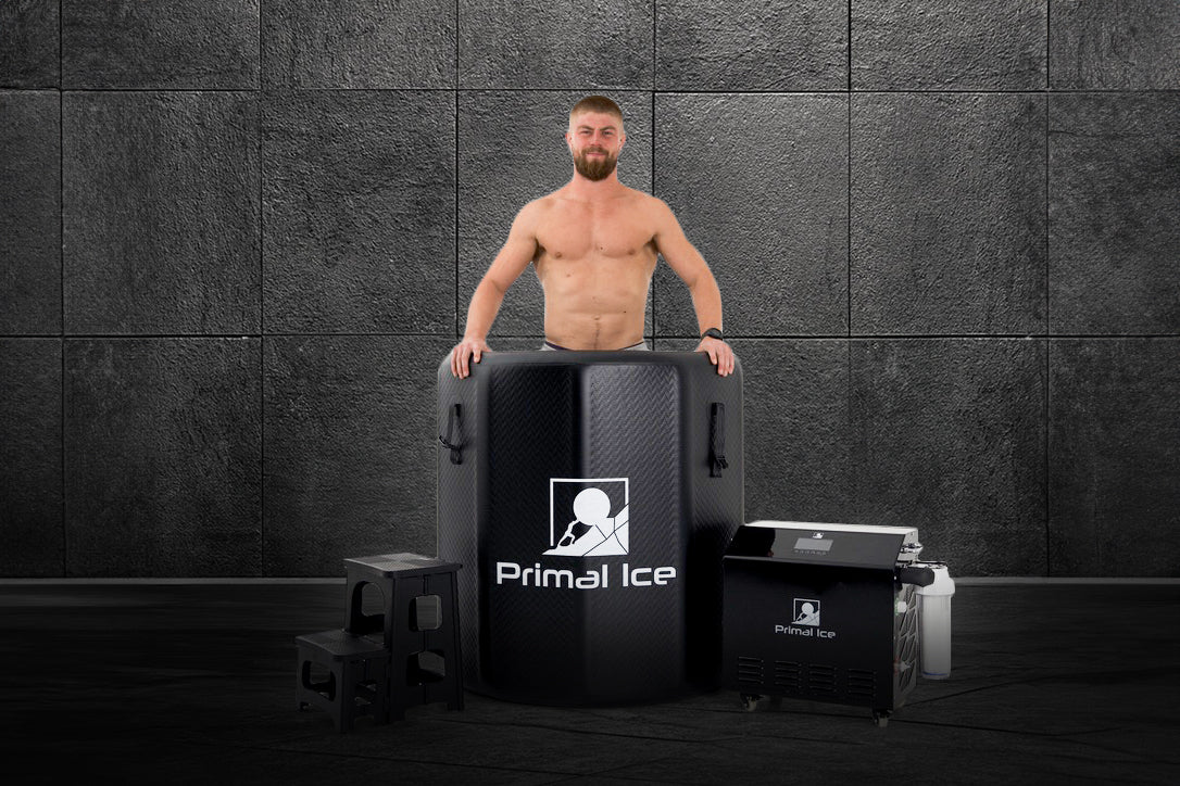 man inside ice bath barrel next to steps and a commercial ice bath chiller